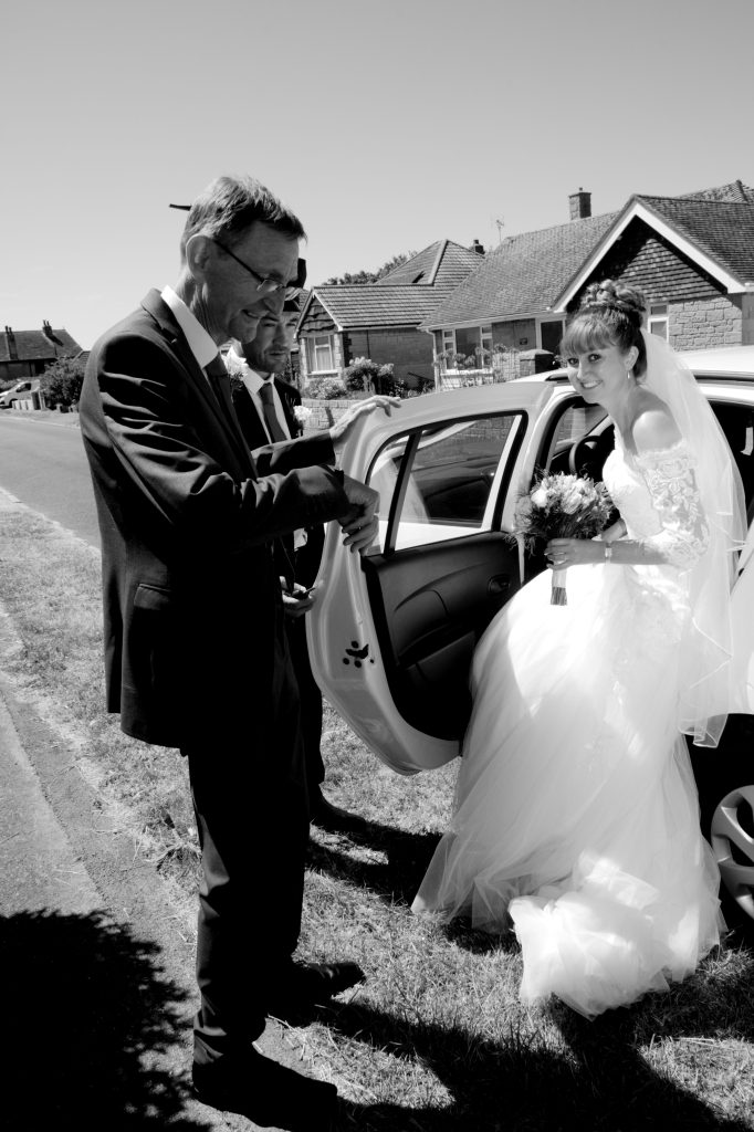 Black & White Image - Father opening door for bride
