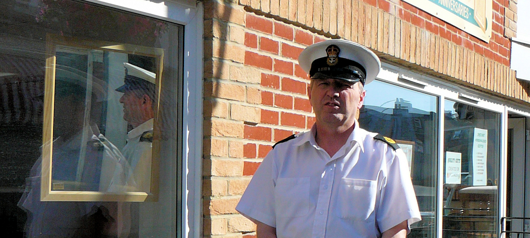 Blog Post Cover Image - John D Henry BA BSc of JD Photography outside shop in Royal Navy uniform.