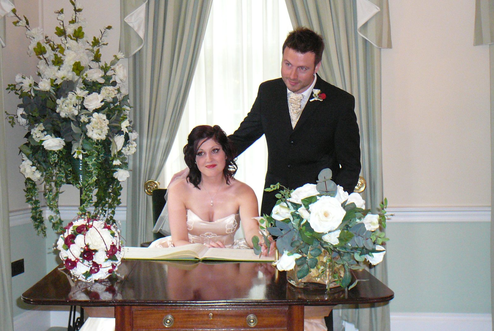 Image by JD Photograph Isle of Wight Wedding Photographer - Top picture of bride and groom signing register.